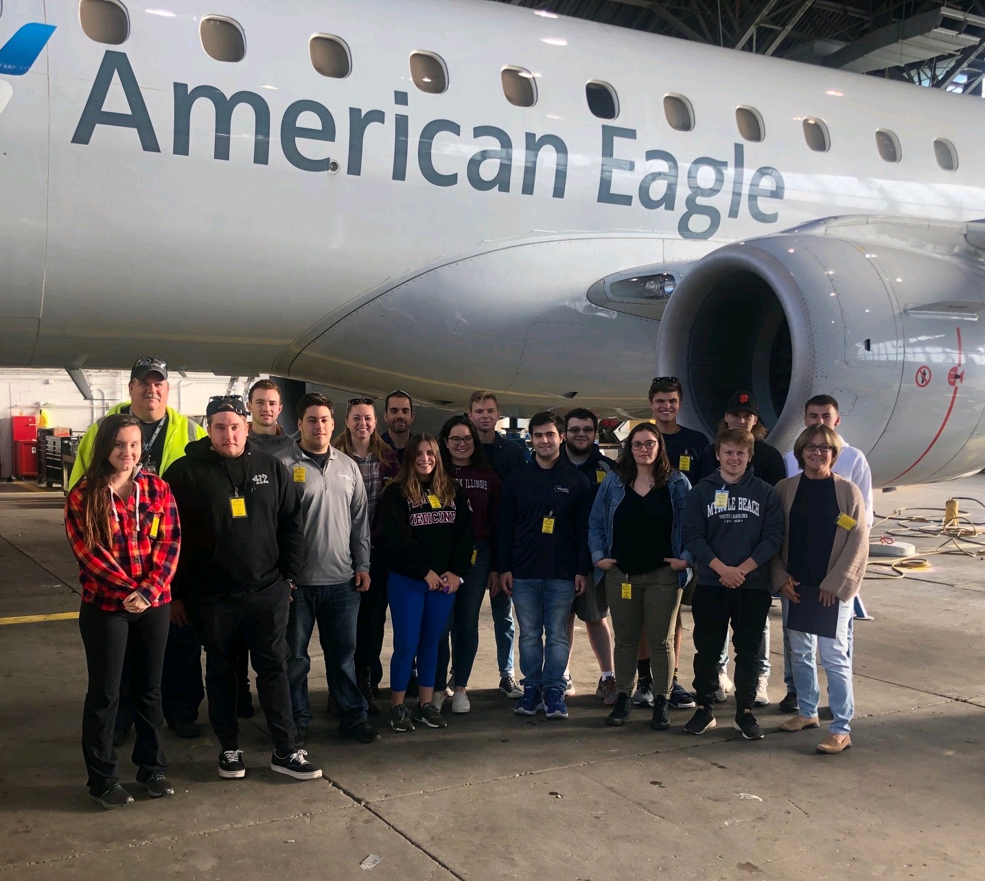 Aviation Management group in front of plane